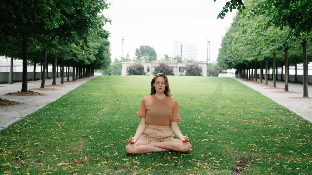 Woman meditating on the grass